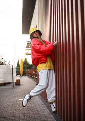 Teenager girl in colorful youth urban style clothing on town street