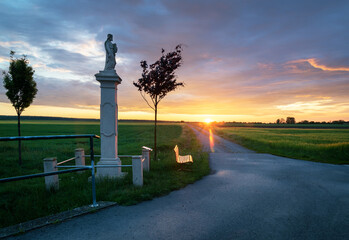 sunrise on a country road with road cross