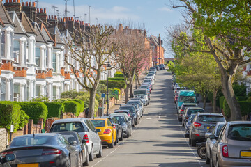 London street lined with terraced houses and parked cars around Crouch End area