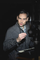 An influencer, artist and musician, speaks to the camera in one of his videos for social networks, while explaining how to record the sound and samples of an electric piano keyboard, Spain.