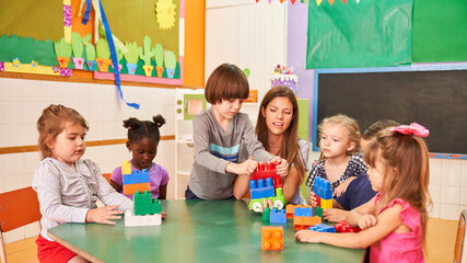 Group of multicultural children playing with building blocks