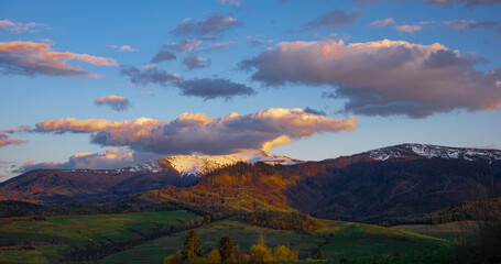 High perspective view of the mountains during sunset. Some mountain peaks. The concept of landscape and nature.