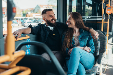 Couple sitting in a bus while talking and flirting