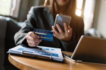  hand using tablet ,laptop, and holding mobile with credit card online banking payment shopping.