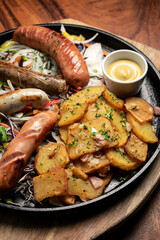 mixed german traditional organic sausage and potato meal platter