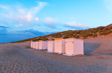 Beach cabins at sunset near Oostende (Ostend), Bredene, West Flanders, Belgium.