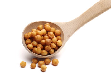 Salty fried crispy wheat pastry balls for soup in wooden ladle, spoon isolated on white background