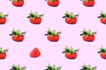 Seamless pattern from top of strawberries with green leaves on a pink background