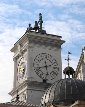 detail of the famous clock tower and two bronze statues above in the main square of the city of Udine in Italy