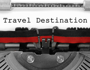 Travel Destination text writen with an old typewriter on white paper
