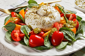 Spinach, Tomato and Burrata Salad on a plate