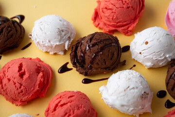 Scoops of gelato on golden surface, ice cream