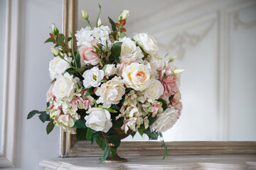 Delicate wedding bouquet of roses in a vase on the table.