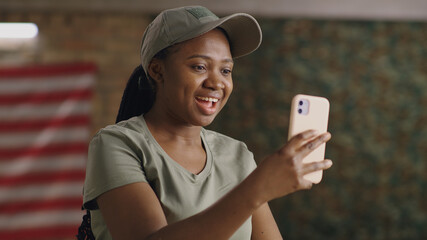 Cheerful African American female soldier making video call to friend - obrazy, fototapety, plakaty