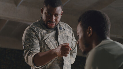 African American commander scolding soldier