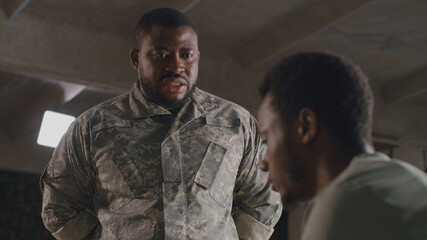 African American commander scolding soldier