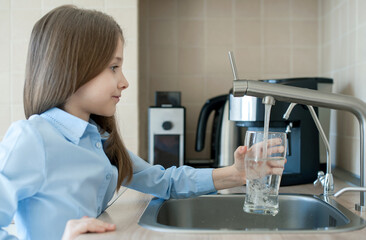 Child open water tap. Kitchen faucet. Glass of clean water. Pouring fresh drink. Hydration. Healthy...