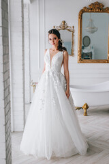 Fototapeta premium Charming and beautiful bride in luxury fashion wedding dress in studio