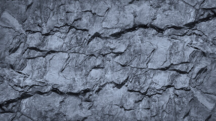 Gray rock texture with cracks. Stone wall background with copy space for text and design. Wide...