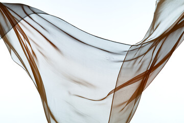 Smooth elegant transparent cloth separated on white background. Texture of flying fabric.