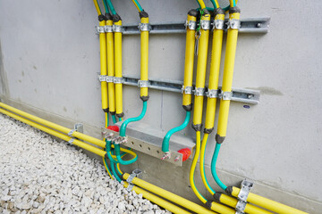 Electrical high voltage ground copper bar on wall. Grounding electric bar. Cables connected to...