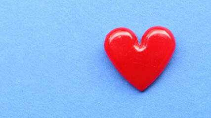 Red heart on blue paper. Background on health care or love theme.