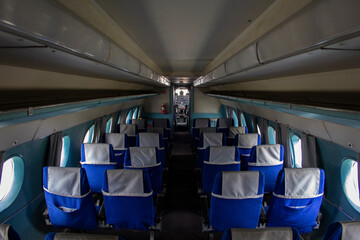 The cabin of a small passenger old plane. Empty cabin of an old liner. The salon is ready to receive passengers