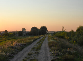 Fototapeta na wymiar beautiful evening road to the village