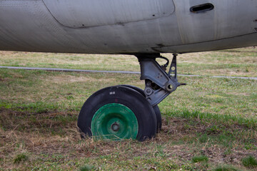 An-24 is a turboprop passenger aircraft for short and medium-haul lines. An old liner stands on the grass.