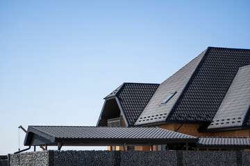 Brown corrugated metal profile roof installed on a modern house. The roof of corrugated sheet....