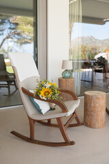 Mediterranean terrace with sunflowers bouquet in a rocker