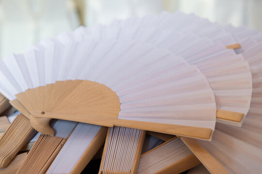 white and wooden fans for Spanish celebration