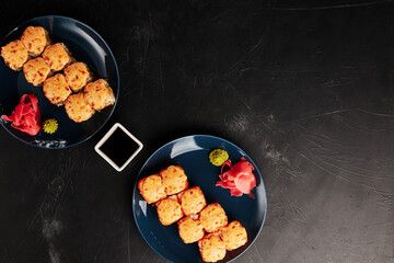 baked rolls in plates on a black textured background