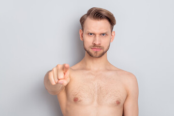 Photo of strict young blond man point blame you without clothes isolated on grey color background