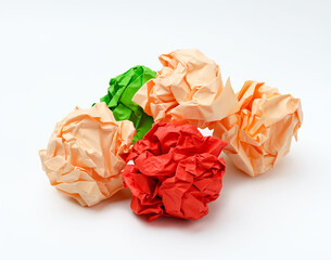 multicolored crumpled paper balls on white background