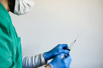 Nurse or doctor holds a covid-19 vaccine in his hands