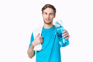 sporty man in blue t-shirt water bottle towels workout