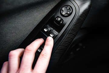 Hand press on car automatic window control.