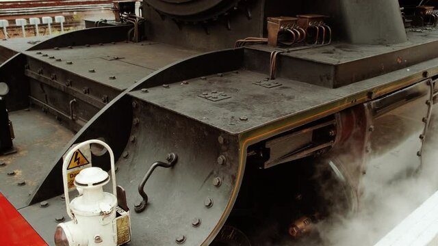 Stunning detail of a steam locomotive preparing to depart on a heritage trip