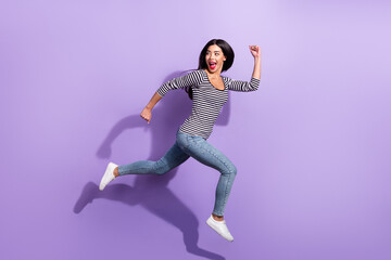 Fototapeta na wymiar Full size profile side photo of young funky cheerful woman running fast look copyspace isolated on violet color background