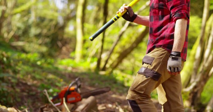 Portrait of a strong lumberjack in plaid shirt taking a break