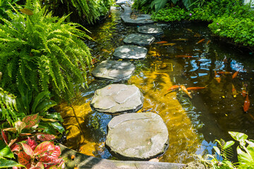 Stone platform, walkway across the garden fish pond
