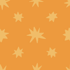 Seamless pattern with hand drawn doodle gold stars on an orange background. Contemporary boho texture in doodle style for wrapping paper, covers and fabric.