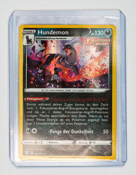 Hamburg, Germany - 05212021: front side photo of the German TCG pokemon kampfstile holo Houndoom (BST 96) card in sleeve and top loader.