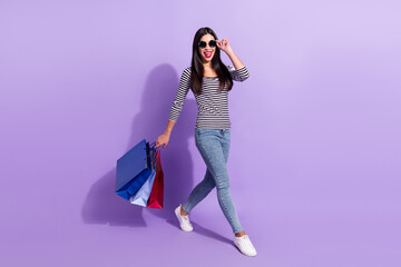 Full size photo of young beautiful good mood korean girl shopaholic go walk after shopping isolated...