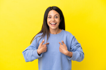 Young caucasian woman isolated on yellow background with surprise facial expression