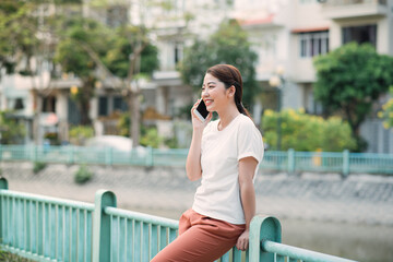 Fototapeta premium Young Beautiful Woman Talking On Mobile Phone Outdoor.