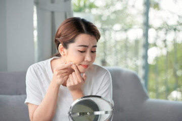 Young woman with pimple on her face