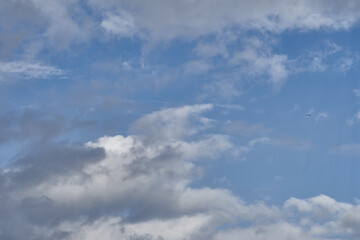 Fototapeta na wymiar Dramatic thunderclouds float across the blue sky
