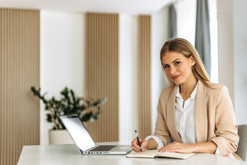 Young woman, working hard, signs contracts.